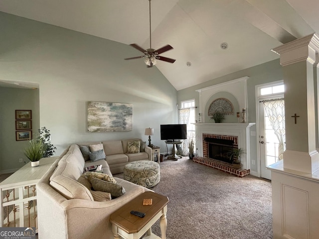 living area featuring a fireplace, decorative columns, a wealth of natural light, and light colored carpet