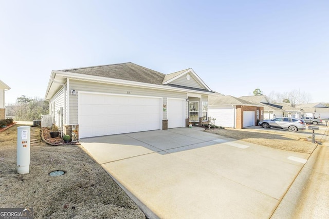 ranch-style house featuring concrete driveway, stone siding, and an attached garage