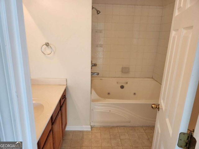 bathroom with a combined bath / shower with jetted tub and vanity