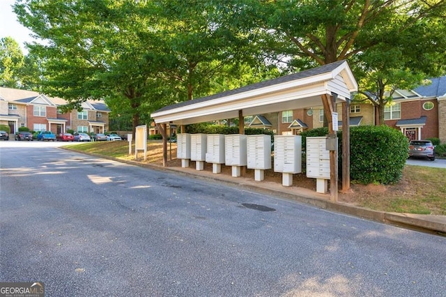 view of home's community featuring a residential view and mail area