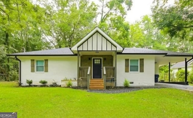 view of front of home featuring aphalt driveway, crawl space, a carport, board and batten siding, and a front yard