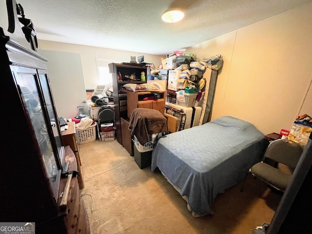 bedroom with a textured ceiling and light colored carpet