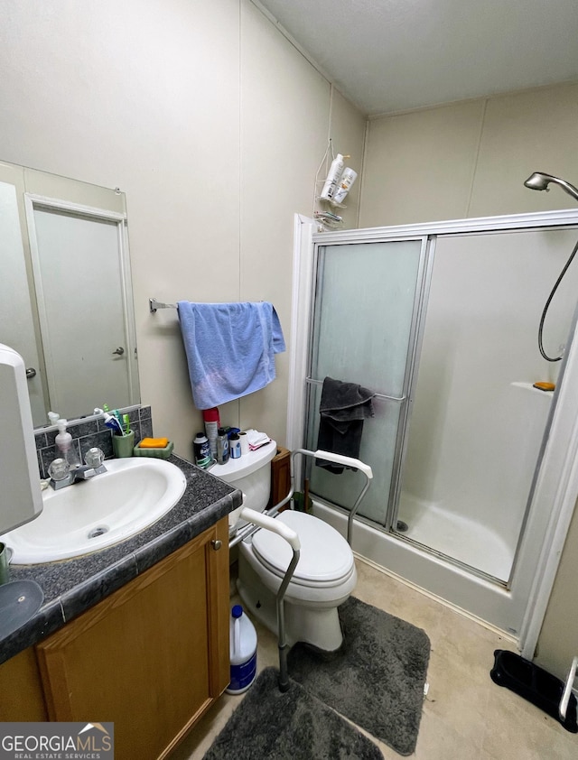 full bathroom with toilet, a shower stall, and vanity