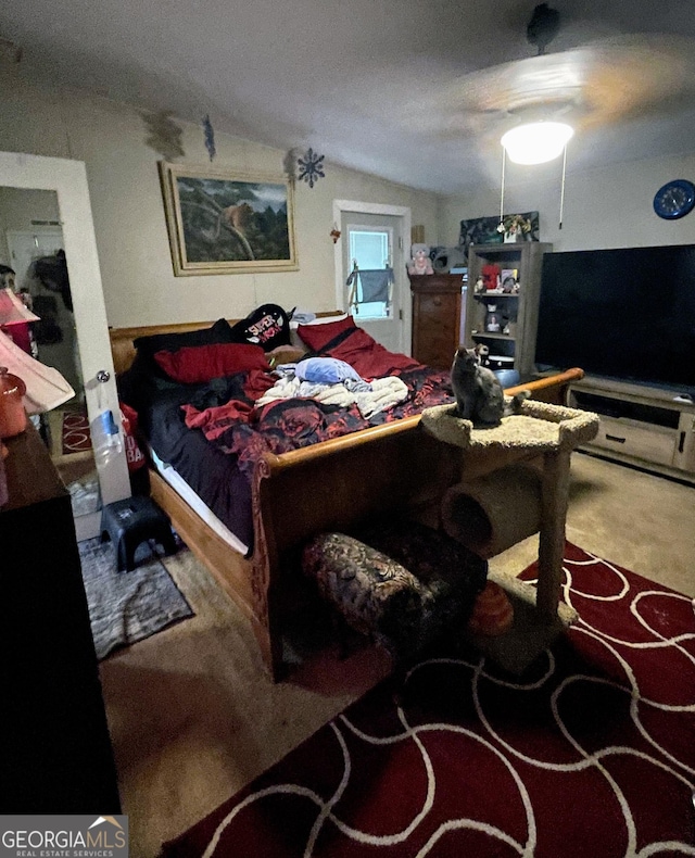 bedroom with lofted ceiling and carpet