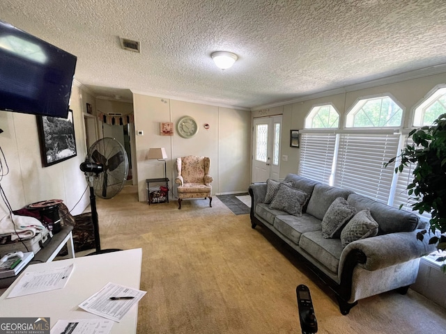 living room with ornamental molding, visible vents, and a textured ceiling