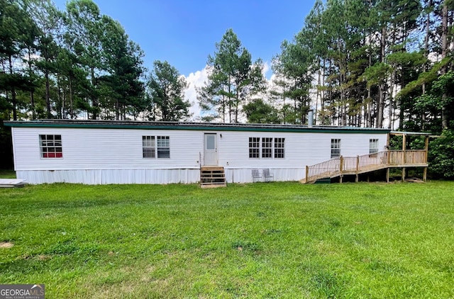 back of house featuring a deck and a yard