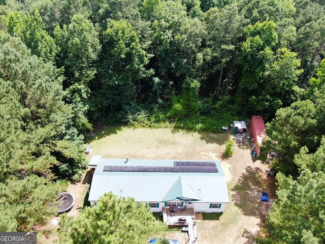 drone / aerial view with a wooded view