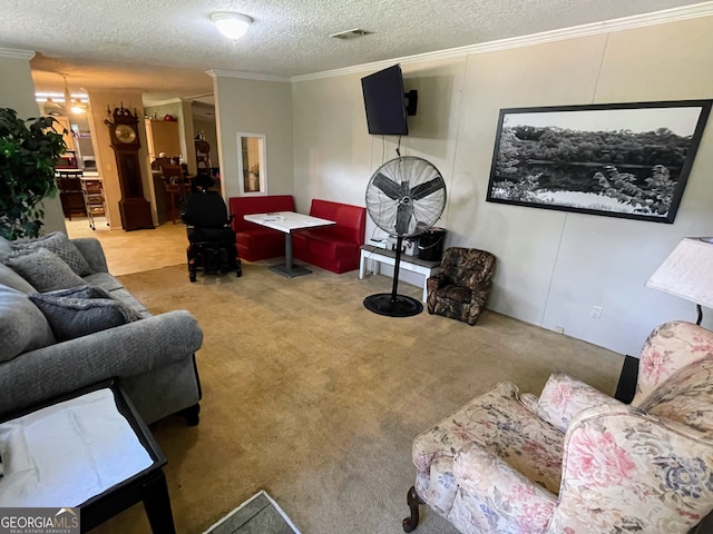 carpeted living area featuring a textured ceiling, ornamental molding, and visible vents