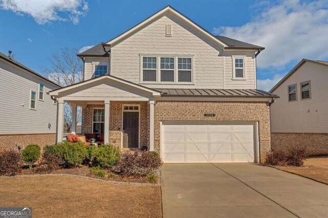 view of front of property featuring concrete driveway, metal roof, an attached garage, a standing seam roof, and brick siding