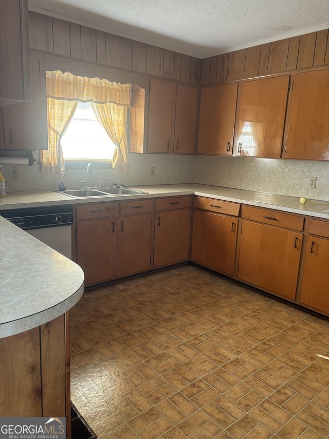 kitchen with tasteful backsplash, light countertops, stainless steel dishwasher, and brown cabinets