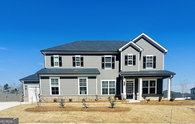 view of front of property with concrete driveway, brick siding, and an attached garage