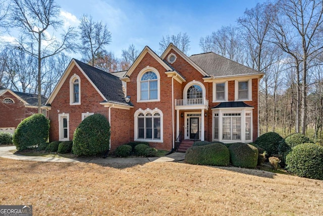 view of front of house with a front yard and brick siding