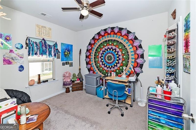 interior space featuring baseboards, carpet floors, visible vents, and a ceiling fan