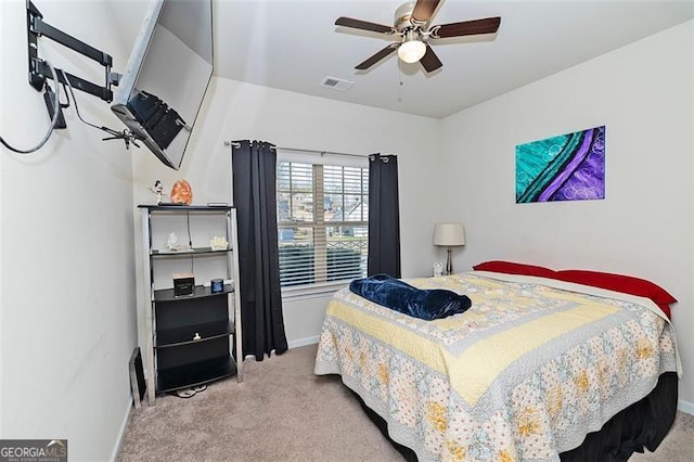 bedroom with baseboards, a ceiling fan, visible vents, and light colored carpet