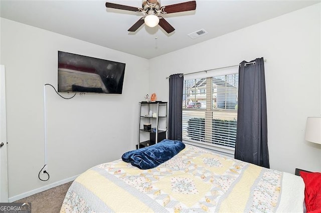 bedroom featuring a ceiling fan, carpet flooring, visible vents, and baseboards