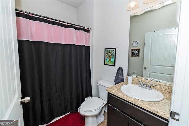 bathroom with toilet and vanity