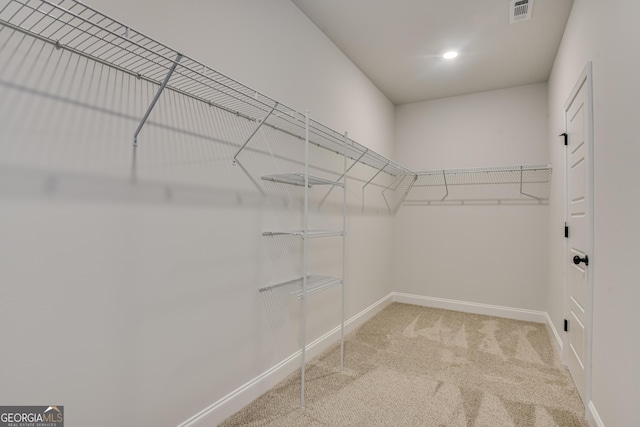 walk in closet featuring carpet floors and visible vents