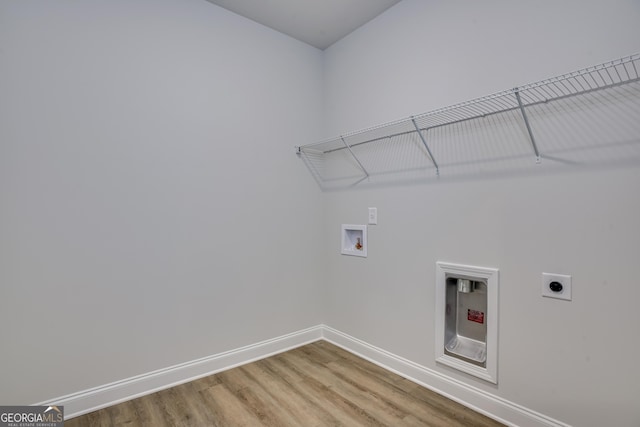 laundry room with laundry area, baseboards, wood finished floors, hookup for an electric dryer, and washer hookup