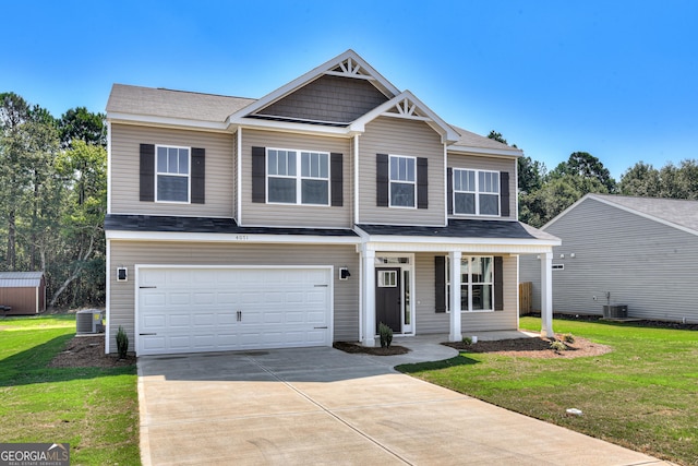 view of front facade with a porch, an attached garage, cooling unit, driveway, and a front lawn