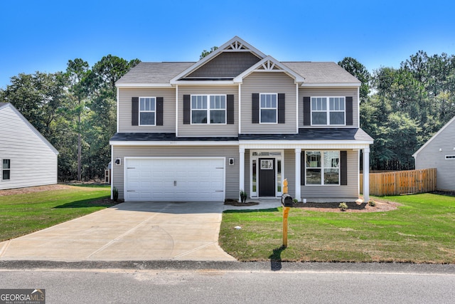 view of front of house with a garage, a front yard, concrete driveway, and fence