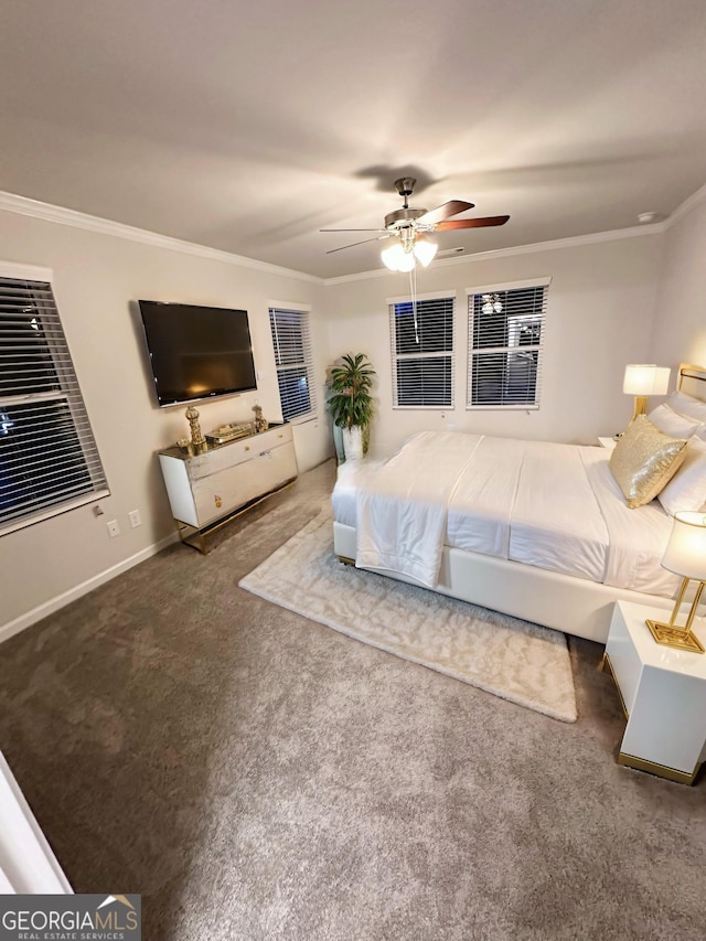 bedroom with ceiling fan, baseboards, dark colored carpet, and crown molding