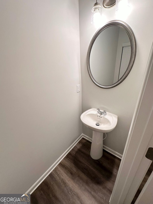 bathroom featuring baseboards and wood finished floors