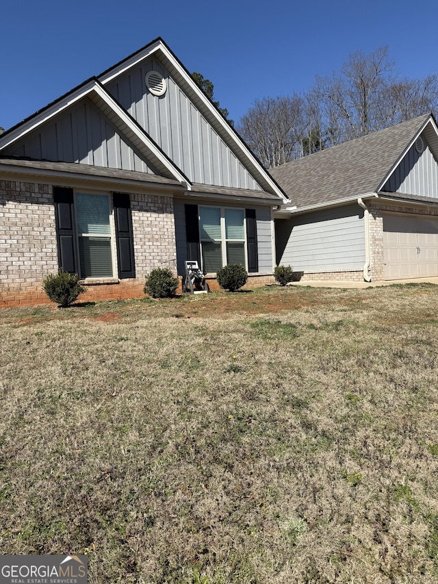 ranch-style home with a front lawn, board and batten siding, and brick siding