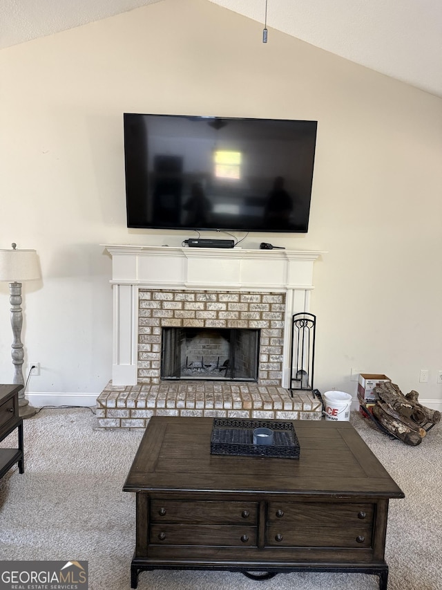 living room featuring lofted ceiling, a brick fireplace, light carpet, and baseboards