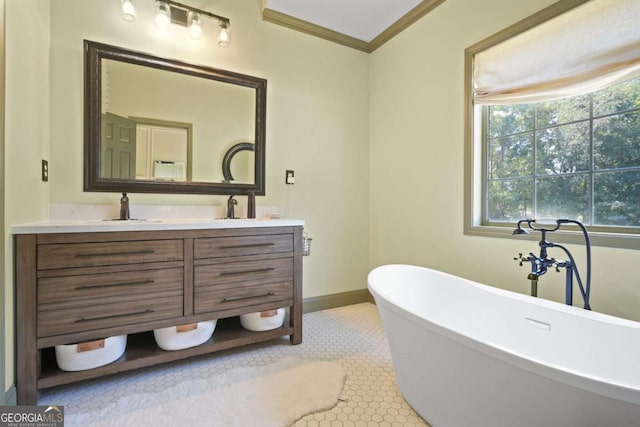 bathroom with a sink, baseboards, a soaking tub, double vanity, and crown molding