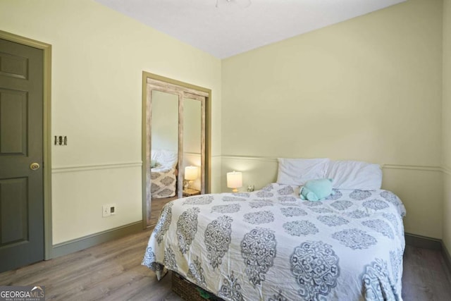 bedroom featuring baseboards and wood finished floors