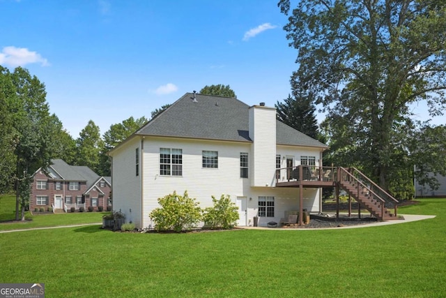 back of property featuring stairs, a yard, a chimney, and a wooden deck