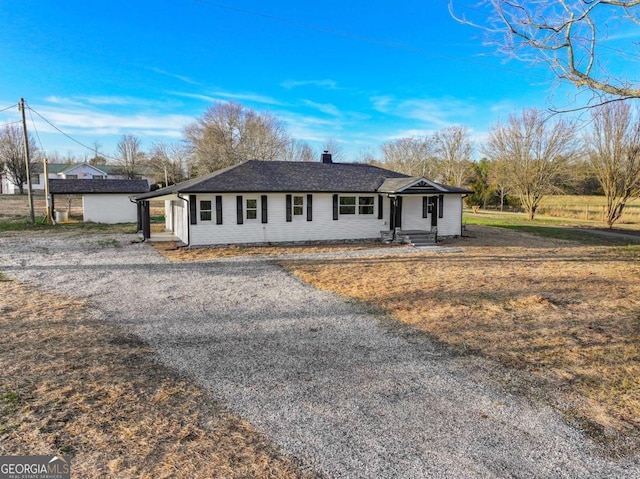 single story home with driveway, roof with shingles, and a chimney