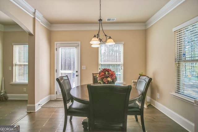 dining room featuring plenty of natural light, visible vents, and crown molding