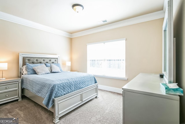 bedroom with baseboards, visible vents, dark colored carpet, and ornamental molding