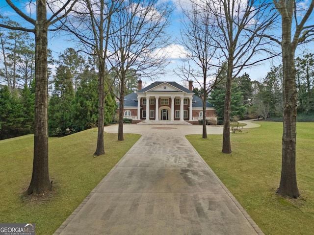 view of property's community with a yard and driveway