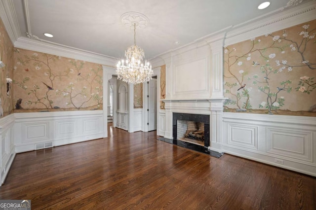 unfurnished living room with ornamental molding, visible vents, a fireplace, and wallpapered walls