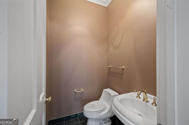 bathroom with tile patterned flooring, a sink, and toilet