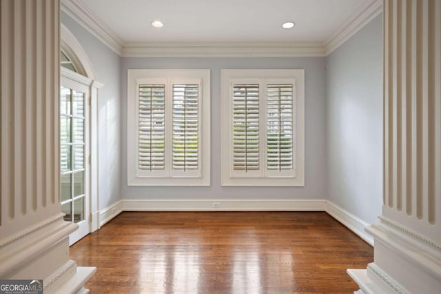 unfurnished room featuring dark wood-style flooring, crown molding, and recessed lighting