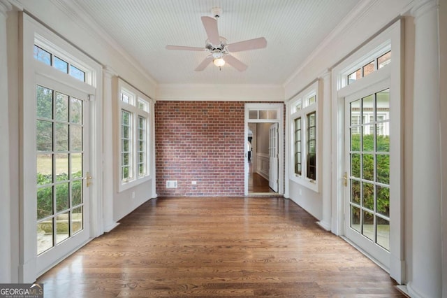 unfurnished sunroom with a wealth of natural light and a ceiling fan