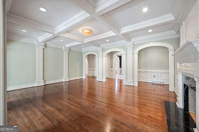 unfurnished living room with decorative columns, visible vents, coffered ceiling, a fireplace with flush hearth, and beamed ceiling