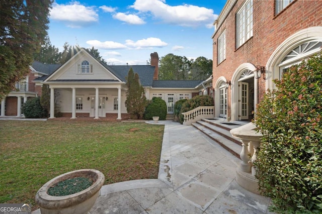 exterior space featuring a front lawn and brick siding