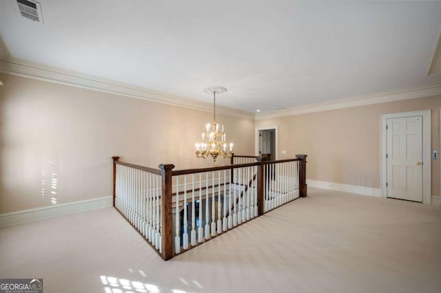 hall with a chandelier, an upstairs landing, visible vents, baseboards, and carpet