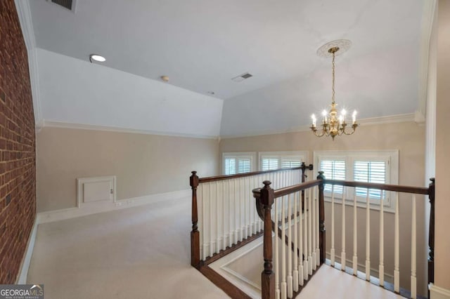 hall featuring lofted ceiling, visible vents, a chandelier, and an upstairs landing