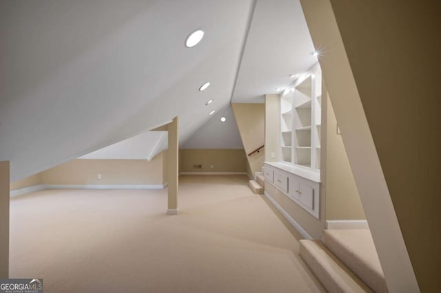 additional living space featuring lofted ceiling, recessed lighting, baseboards, and light colored carpet