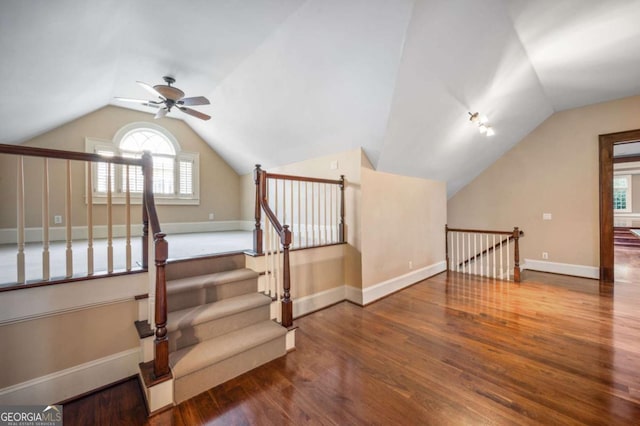 additional living space with lofted ceiling, wood finished floors, a ceiling fan, and baseboards