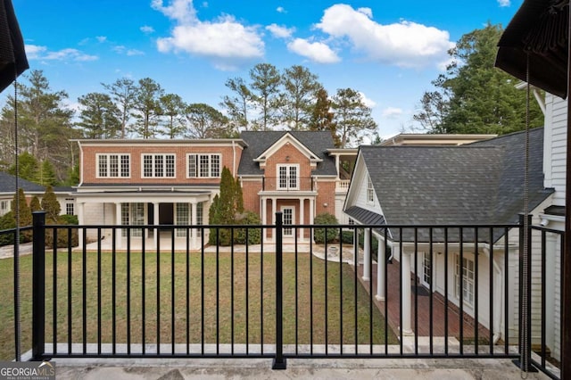 view of front facade with brick siding and a front yard