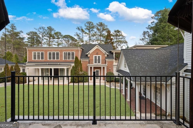 view of gate with a yard