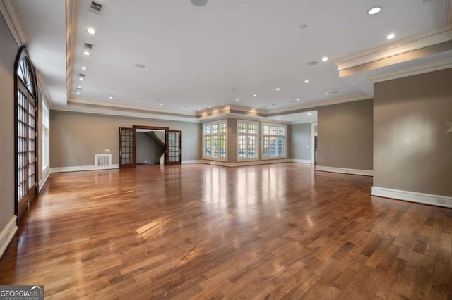 unfurnished living room featuring recessed lighting, wood finished floors, visible vents, and baseboards