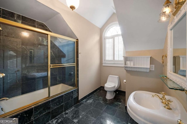 full bath with lofted ceiling, toilet, a sink, tiled shower / bath combo, and baseboards