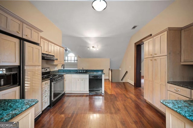 kitchen featuring dark wood finished floors, dishwasher, under cabinet range hood, light brown cabinets, and gas stove